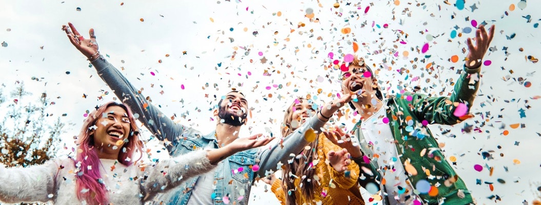 Happy friends celebrating throwing confetti in the air - Young people having outdoor party - Students having fun together at college campus - Youth culture concept