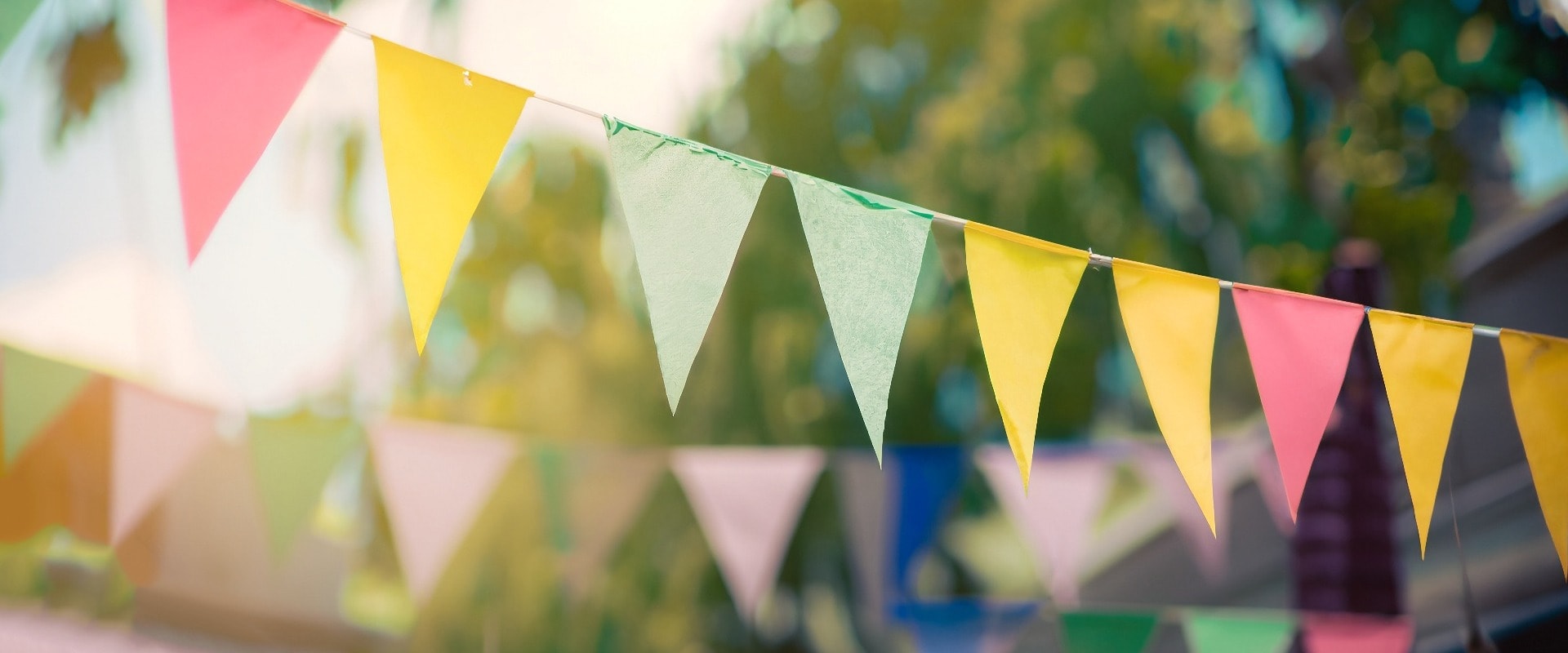 Blur background colorful triangular flags of decorated celebrate outdoor party, vintage tone.