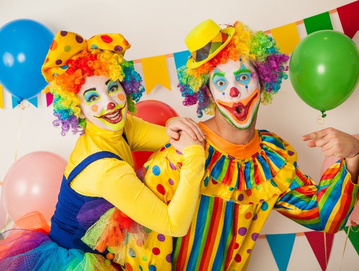 Two cheerful clowns. Birthday for children. Bright clown and clowness.